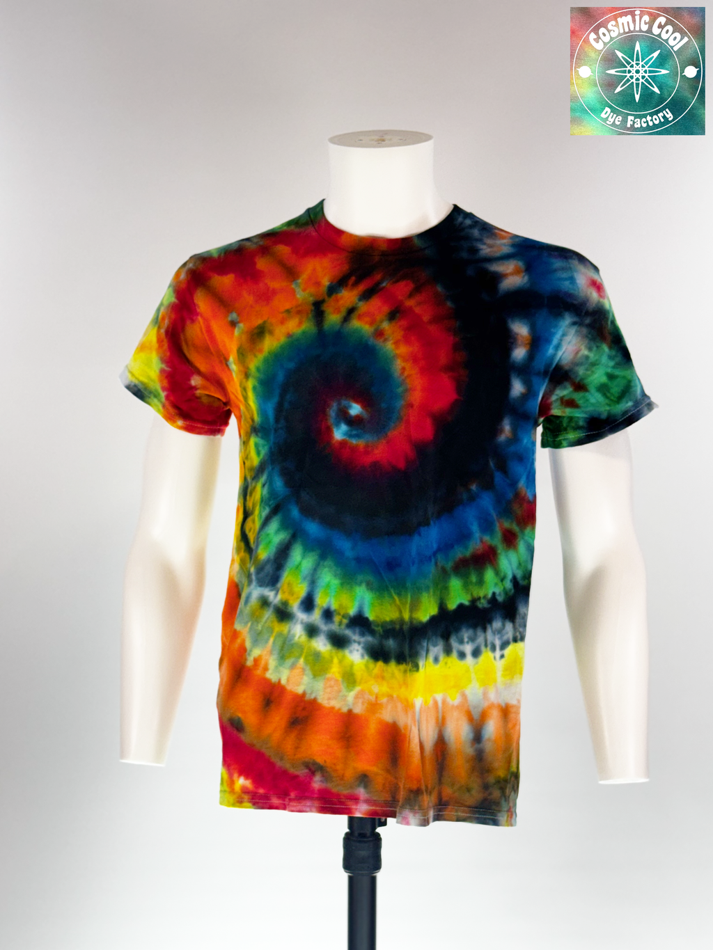 Front view of Medium Short sleeve artisan tee. Event Horizon features a high-saturation, multi-color spiral that creates a sense of powerful gravity. Intense crimsons, neon yellows, and electric blues are pulled into a deep indigo and obsidian core, mimicking the edge of a celestial phenomenon.