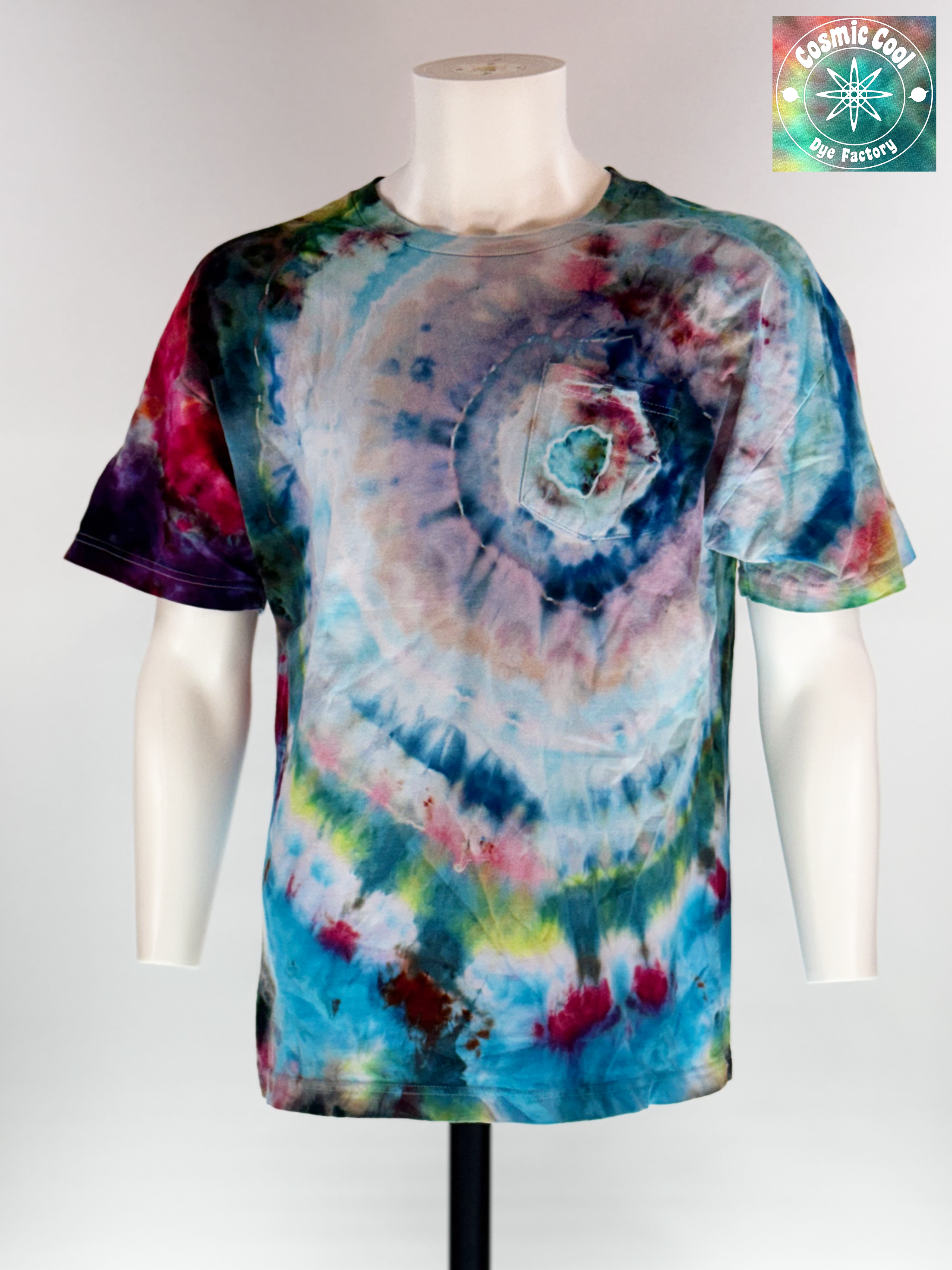 Front view of our Artisan Utility pocket Tee. "Hidden Supernova" explores the moment of a star's rebirth. The design features a swirling vortex of celestial blues, soft pinks, and deep magentas that radiate out from the pocket. Using a specialized ice-crystallization technique, the pigments separate to create intricate, wispy "nebula clouds" across the torso.