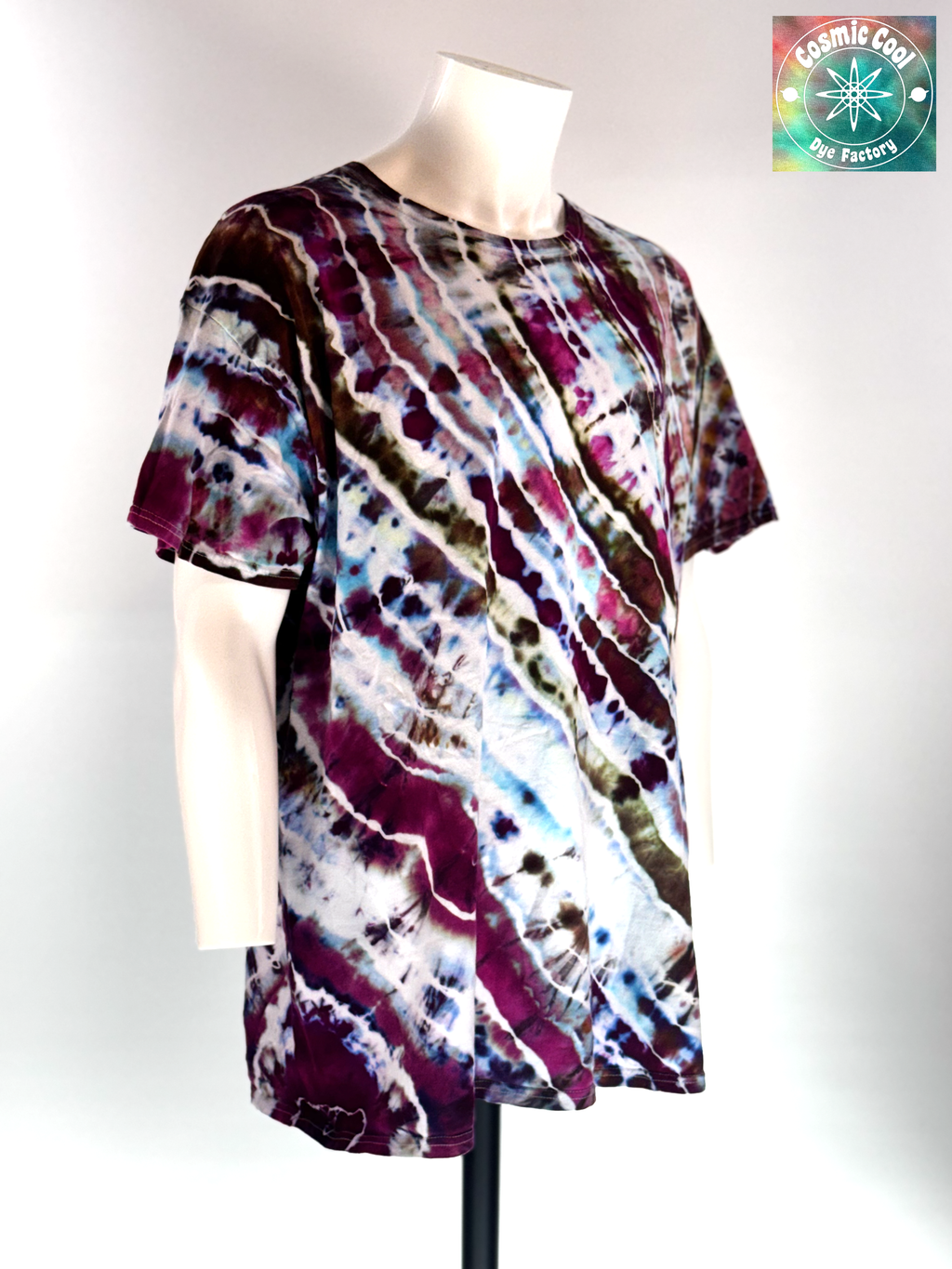 Angled 3/4 Front view of a 3XL Short Sleeve Artisan Tee. Titan's Reach features a powerful, dream-like quality. Imagine deep charcoal and slate "stone" textures being shattered by veins of molten gold and cooling embers. Creating a sense of tactile depth, as if the color is physically emerging from the rock itself.