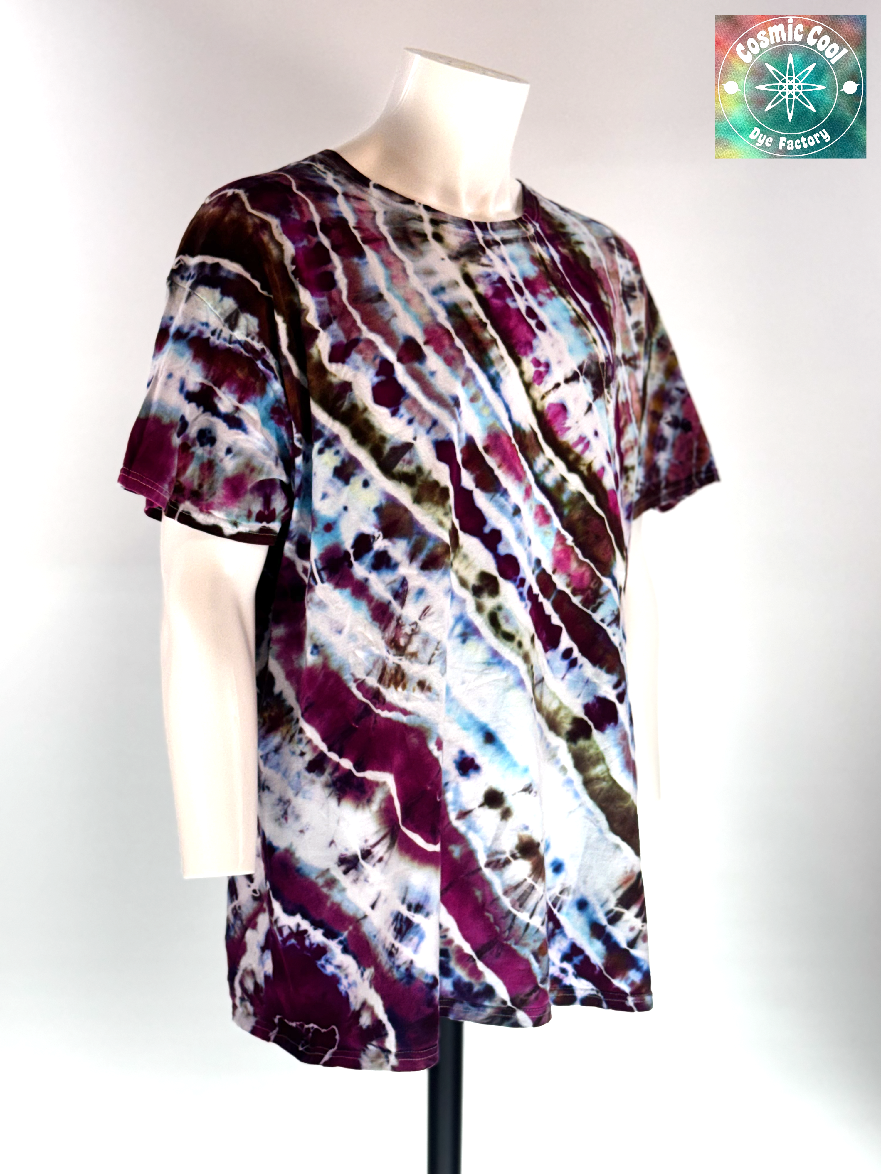 Angled 3/4 Front view of a 3XL Short Sleeve Artisan Tee. Titan's Reach features a powerful, dream-like quality. Imagine deep charcoal and slate "stone" textures being shattered by veins of molten gold and cooling embers. Creating a sense of tactile depth, as if the color is physically emerging from the rock itself.