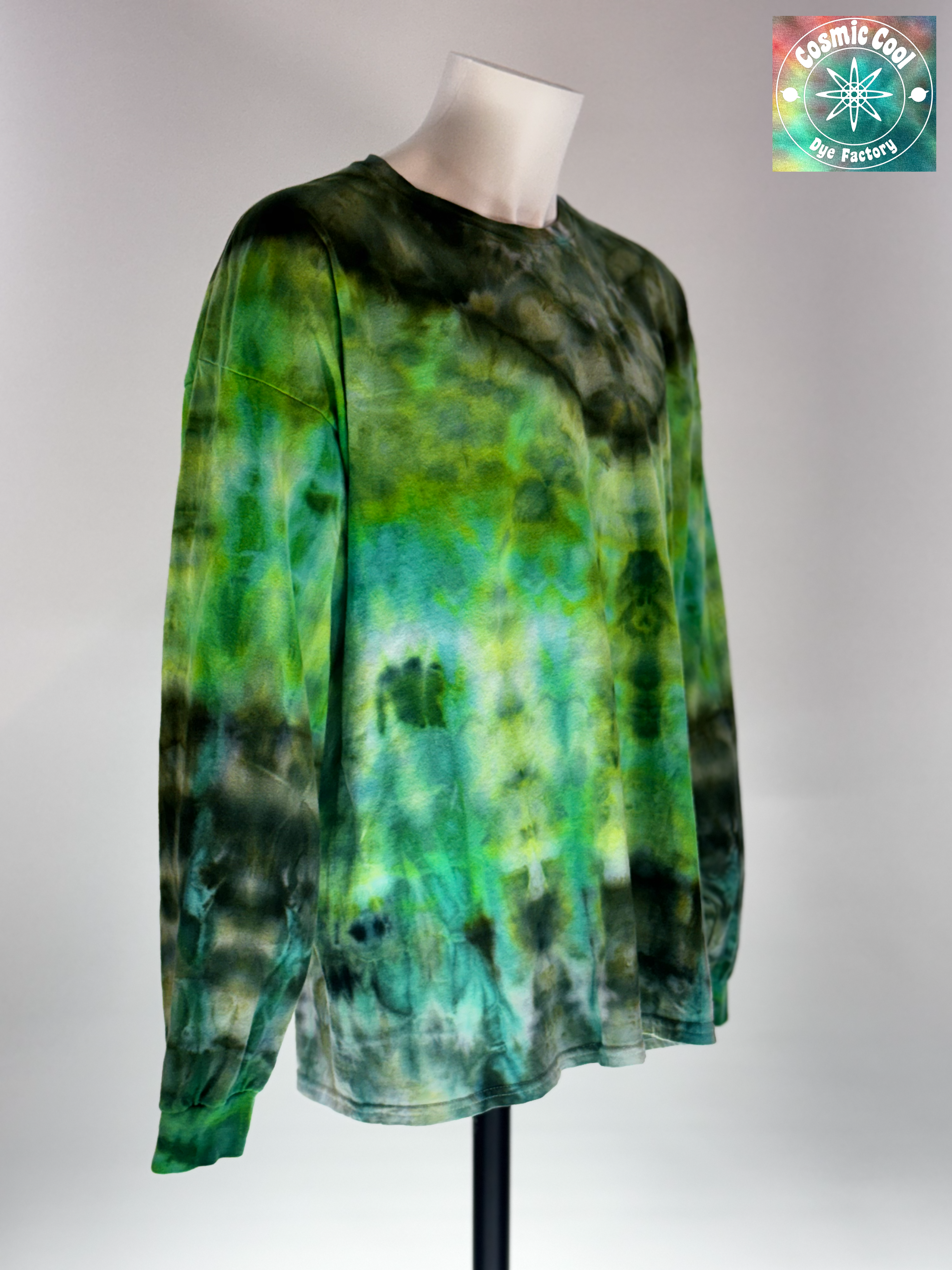 Angled 3/4 Front view of a 3XL Long Sleeve Ice Dye T-shirt. The design features a dark green crystalline patterns radiating across a luminescent field of emerald green.