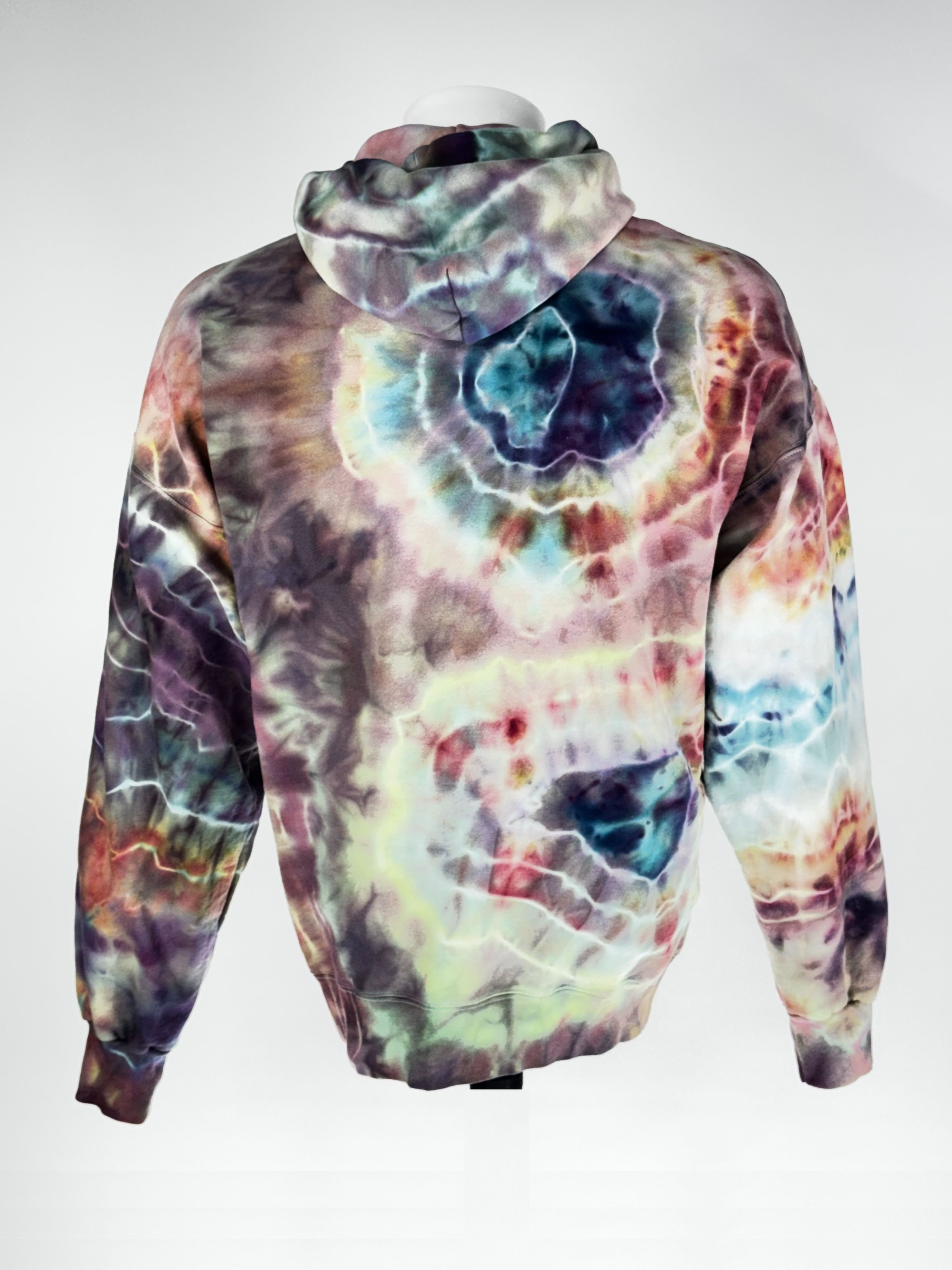 Back view hood down, Manaquine no head. extra-large heavyweight hoodie. "Kinetic Implosion" captures the moment of catastrophic energy collapsing inward.  we have harnessed the slow transition of melting ice to fracture pigments into intricate, high-velocity patterns. The resulting crystalline "shards" of color create a sense of movement and raw power that is unique
