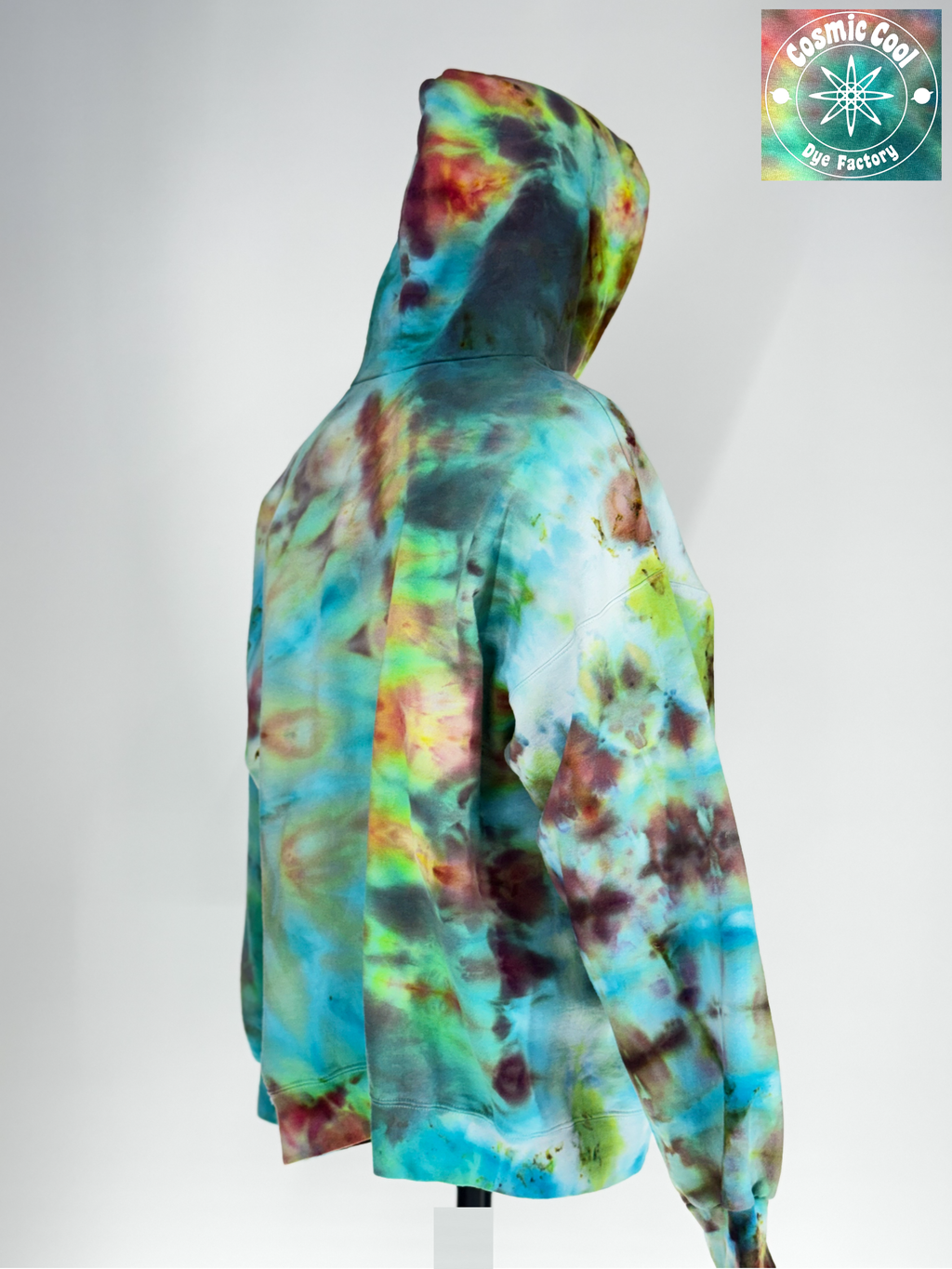 Angled back view of our 2XL Ice-dyed Heavyweight Hoodie.The Vision: "Bioluminescent Void" explores the intersection of total darkness and organic light. The pigments seem to fracture out to a deep obsidian base, with "glowing" crystalline structures in neon-adjacent violets and electric teals. 