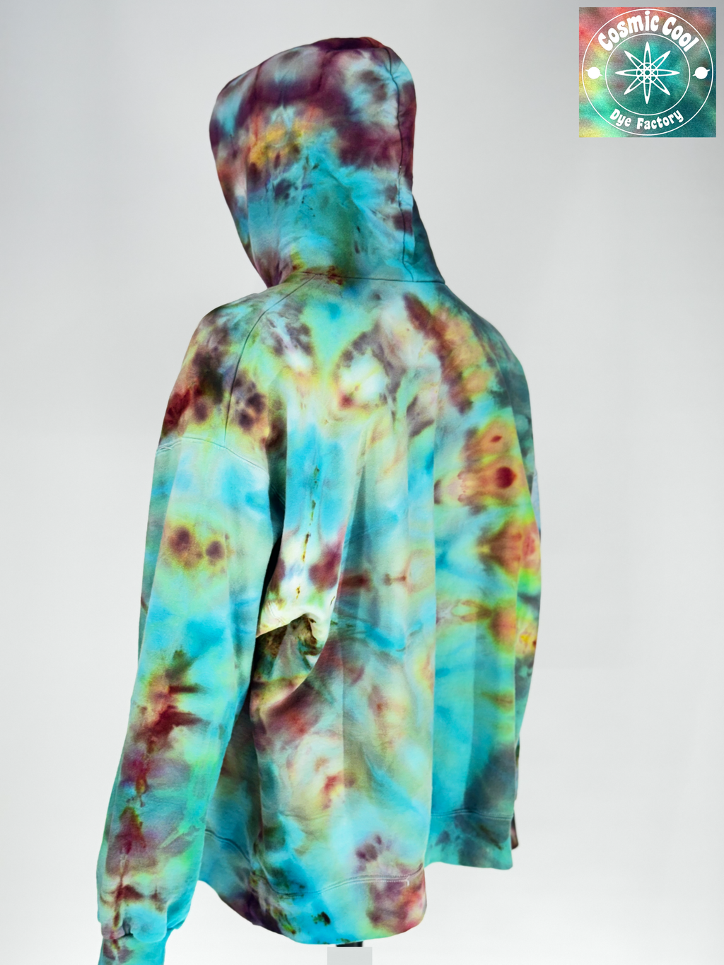 Angled back view of our 2XL Ice-dyed Heavyweight Hoodie.The Vision: "Bioluminescent Void" explores the intersection of total darkness and organic light. The pigments seem to fracture out to a deep obsidian base, with "glowing" crystalline structures in neon-adjacent violets and electric teals. 