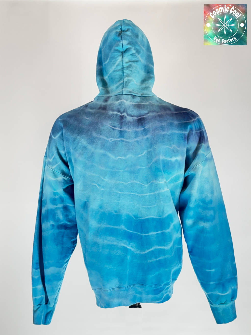 Back view of our 3XL Heavyweight Hoodie.  "Glacial Fracture" mimics the tectonic shifting of an ancient ice shelf. We have allowed pigments to fracture a landscape of deep arctic blues and electric teals "shattered" by veins of brilliant, crystalline white.