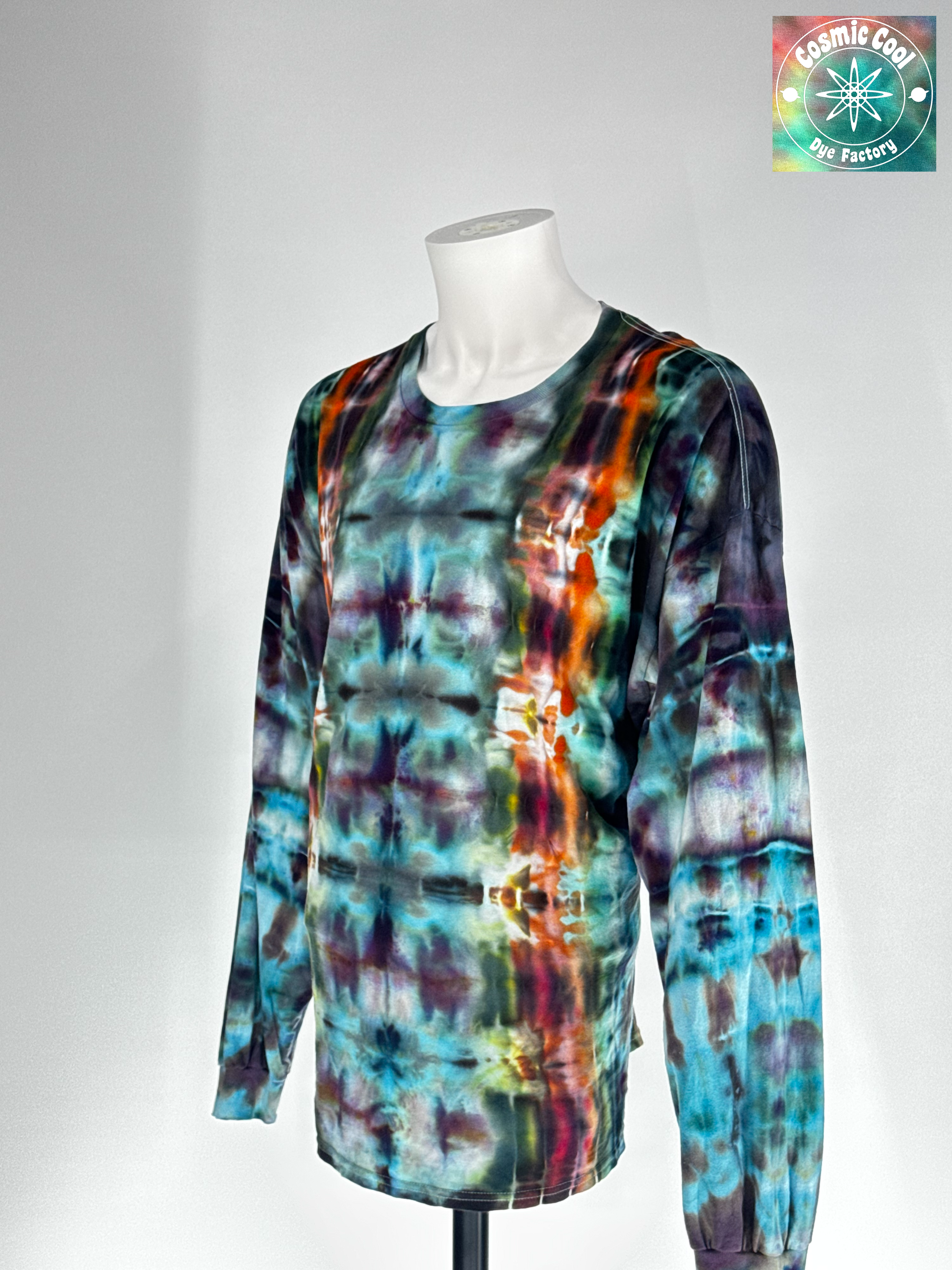 Angled 3/4 Front view of a 3XL long-sleeve ice dye T-shirt featuring the 'Solar Alchemist' design. Intricate, crystalline ice dye patterns in deep amber and burnt orange radiate across a bright, golden-yellow field, creating a high-energy, sun-like quality