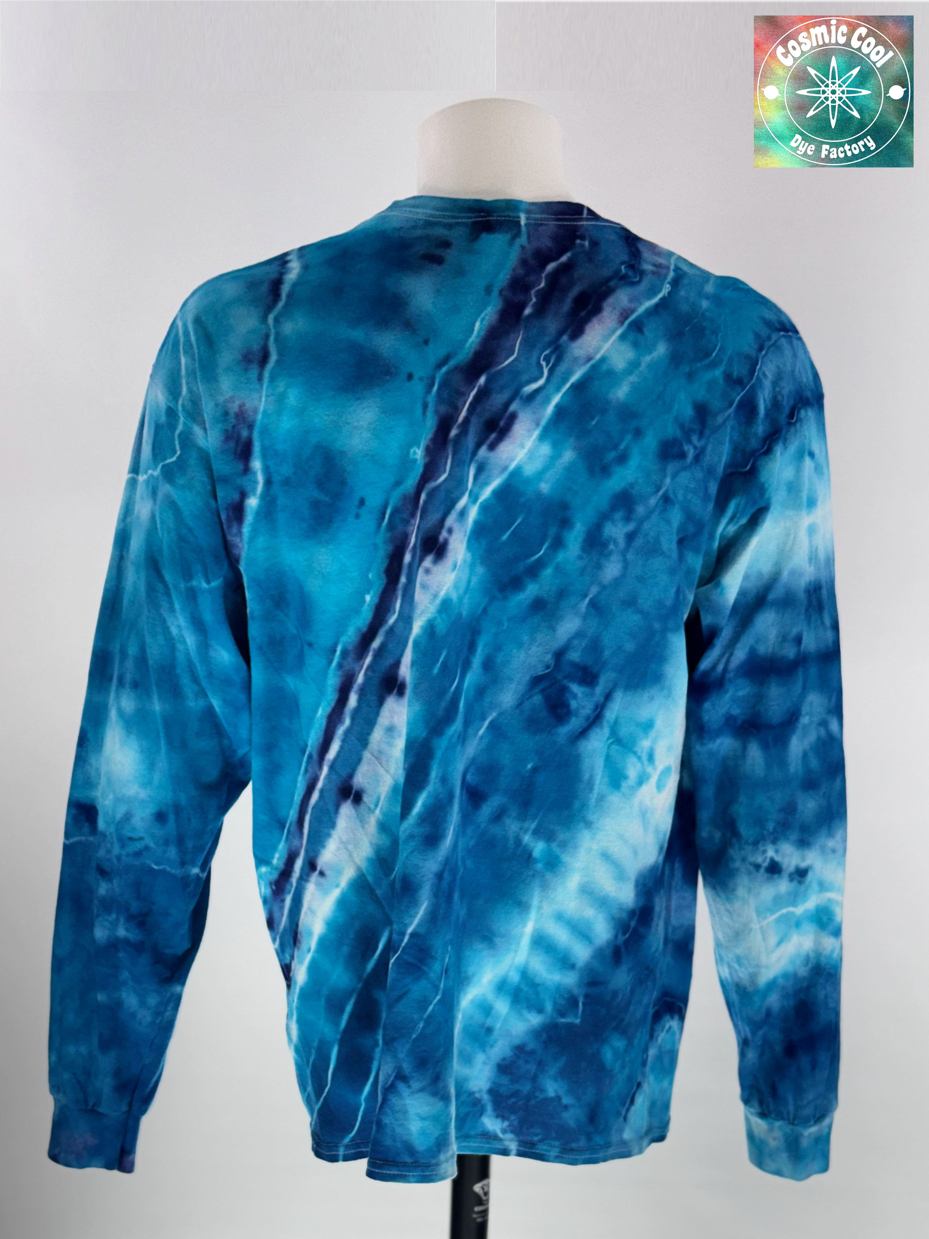 Back view of XL Long Sleeve Ice Dyed Tee Shirt. Glacier Horizon is defined by a deep, diagonal "Tectonic Rift" of competing blues. Navy, Glacier, Cerulean, and Midnight blue that all leave their  Radiant "ice shelves" of turquoise and electric cerulean, creating a complex fracturing of color that mimics ancient, shifting ice. 