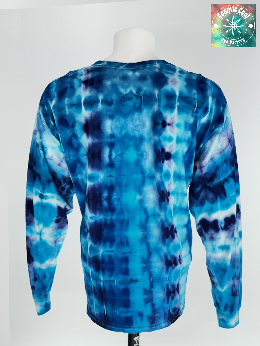 Back view of 2XL Long Sleeve Artisan Tee. Glacial Voyagers" captures the sweeping scale of an arctic landscape. The design features horizontal "drifts" of icy turquoise and deep cerulean, broken by jagged, crystalline lines of white and soft lavender. The ice-dye creating a continuous "voyage" of color that feels vast in its detail.