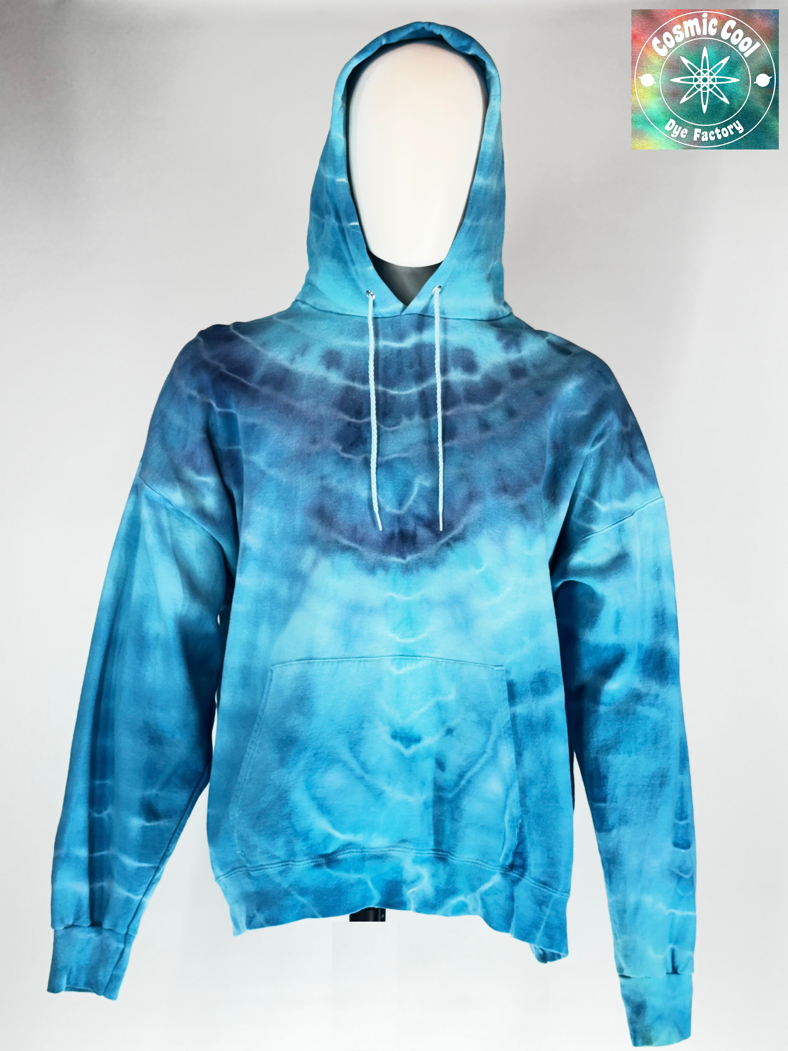 Video of spinning  3XL Heavyweight Hoodie. "Glacial Fracture" mimics the tectonic shifting of an ancient ice shelf. We have allowed pigments to fracture a landscape of deep arctic blues and electric teals "shattered" by veins of brilliant, crystalline white.